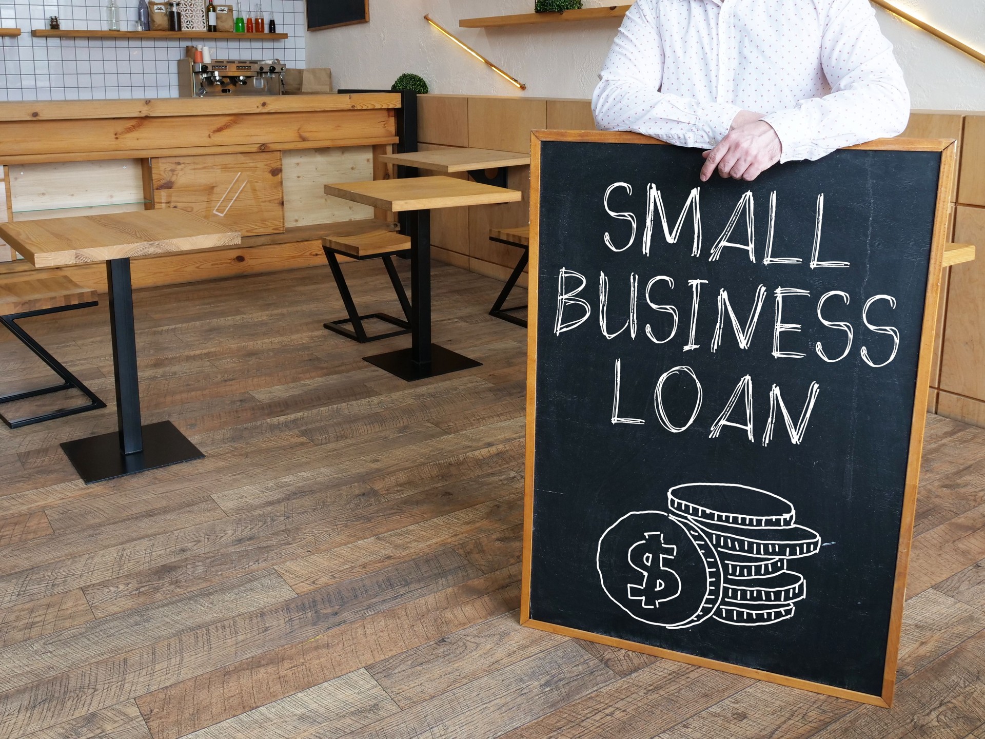 Small business loan is shown using the text and photo of a coffee shop