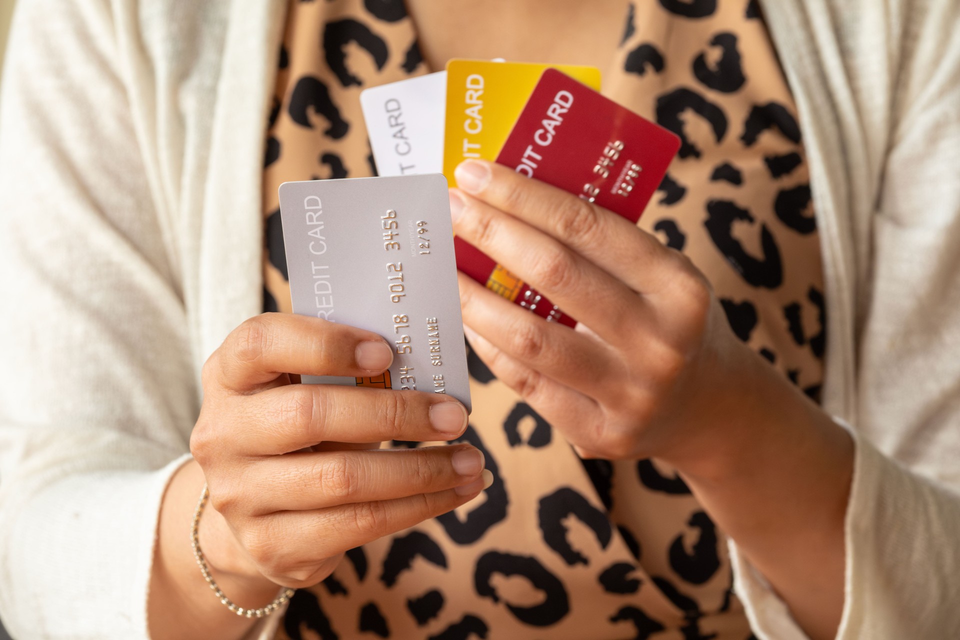 Man holding several credit cards and he is choosing a credit card to pay and spend Payment for goods via credit card. Finance and banking concept.